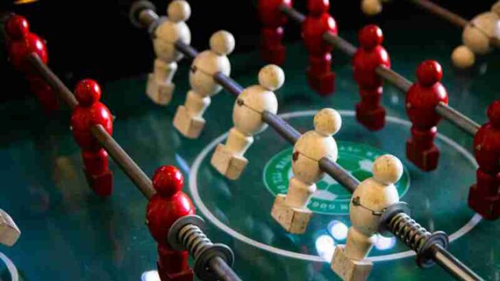 Close-up of red and white foosball players on a classic game table., tags: und - pexel